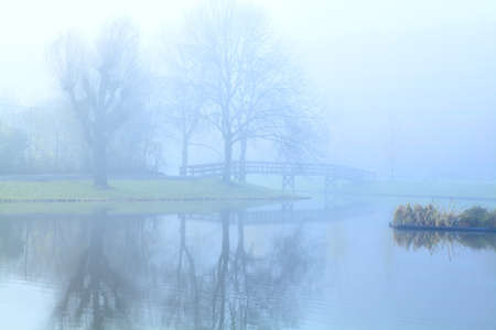dense fog over lake in early morningの写真素材