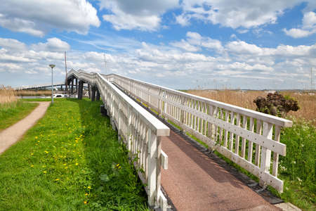 blue sky and long white bridge over river, Alkmaar, North Hollandの写真素材