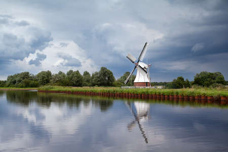 white windmill over clouded sky, Netherlandsの写真素材