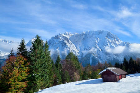 hut on snow meadow in winter Alps, Germanyの写真素材