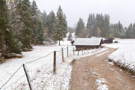 countryside road and wooden hut in winter, Bavaria, Germanyの写真素材