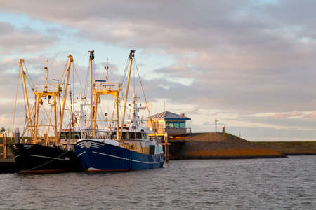 fishing ships on water at harbor, Den Oever, Netherlandsの写真素材