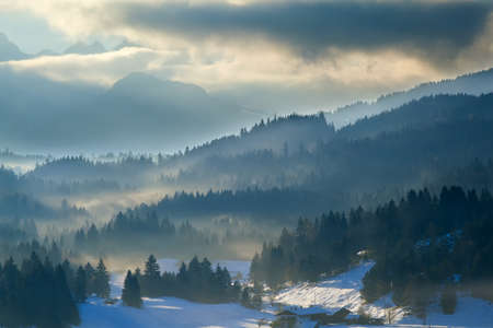 misty sunset in Alps, Bavaria, Germanyの写真素材