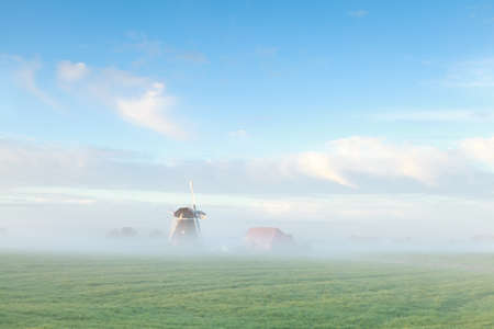 beautiful Dutch windmill in morning mist, Netherlandsの写真素材