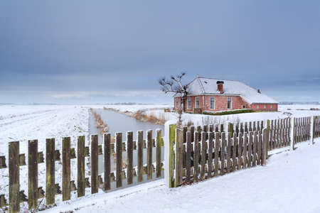 Dutch farmhouse in white snow, Netherlandsの写真素材