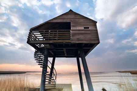 wooden observation tower on Dollard coast, Groningen, Netherlandsの写真素材