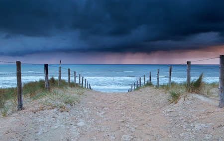 shower coming from north sea to beach path, Hollandの写真素材