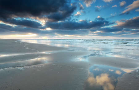 North sea beach at low tide during sunset, Netherlands
