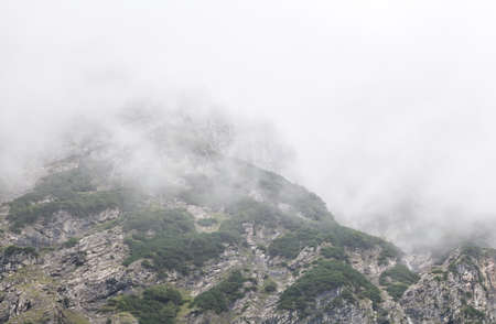 rocky mountains in dense fog, Bavaria, Germanyの写真素材