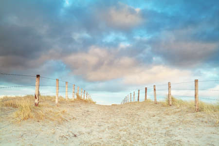 sand path and blue sky, North Holland, Netherlandsの写真素材