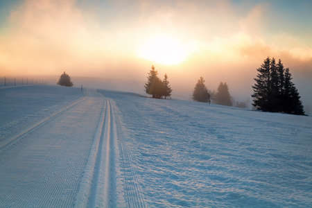 skiing snow path on mountain and sunlightの写真素材