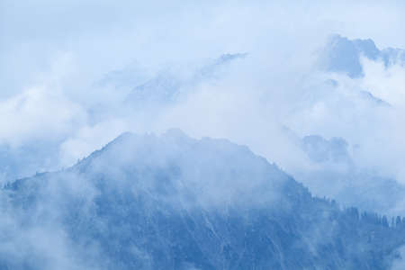 mountain peaks in dense fog after rainの写真素材