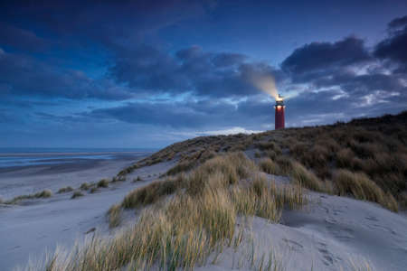 lighthouse on dune in dusk, Texel, Hollandの写真素材