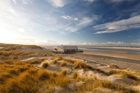 wooden house on North sea beach, Netherlandsの写真素材