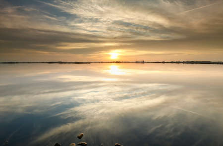beautiful gold sunset over lakeの写真素材