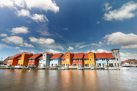 colorful buildings on water on sunny day, Groningen, Netherlands