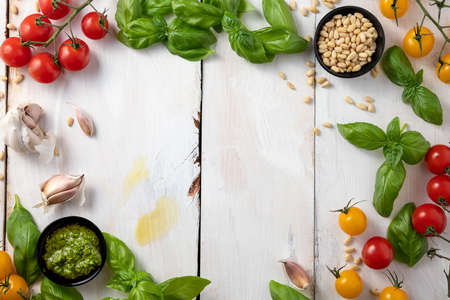 fresh vegetables and greens frame on white table