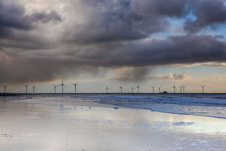 Wind turbines at low tide on the North Sea in Holland, Netherlands