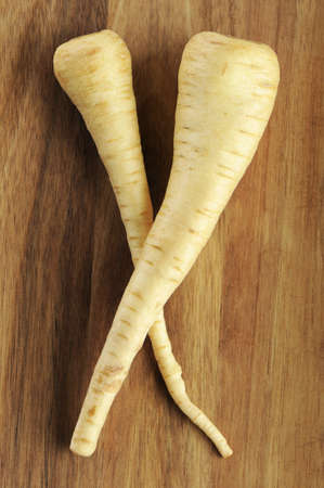 Parsnip on a wooden cutting boardの写真素材