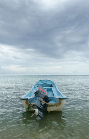 Motor boat on calm sea with dramatic skyの写真素材