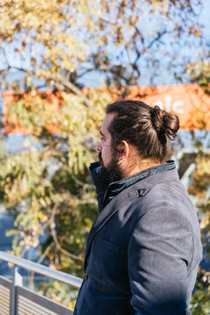 Young business man talking mobile next to the officesの写真素材