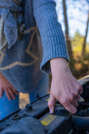 close-up of the hand adult woman repairing car engine