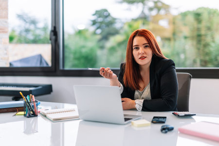 Young woman working on a laptop from homeの写真素材