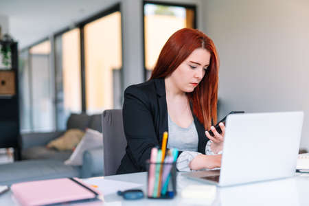 Young woman working on a laptop from homeの写真素材