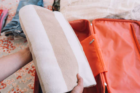 close-up shot of a womans hands preparing the beach equipment for her summer holiday. concept trip...