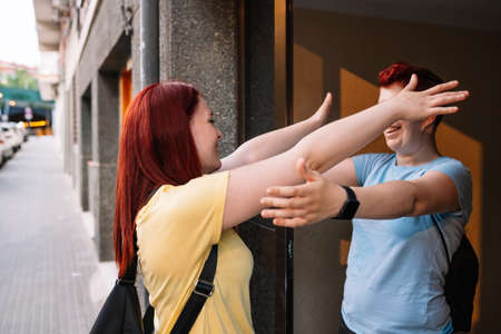 two great friends, happy and very content, meeting again after a long time without seeing each other. young girls in the city sharing free time. concept of friendship and companionship.の写真素材