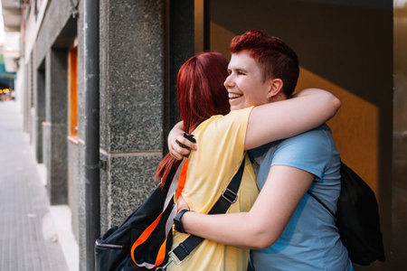 two happy and very content big friends hugging each other, meeting again after a long time without seeing each other. young girls in the city sharing free time. concept of friendship .の写真素材