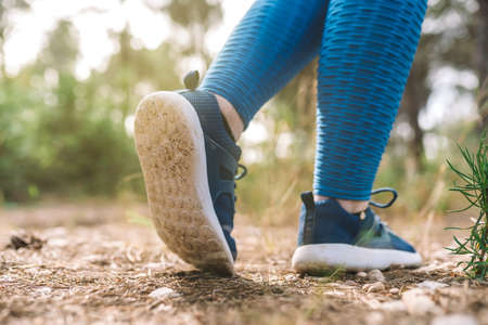 close-up of a young womans blue sports shoes. woman athlete playing sport outdoors. concept of...