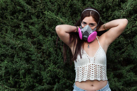 young woman wearing antibacterial mask and latex gloves outdoors as disease prevention and covid-19...