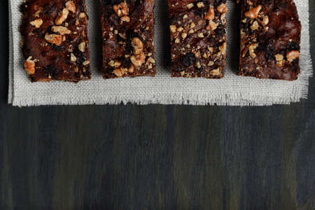 pieces of chocolate brownie on white scarf on top in foreground, healthy food during quarantine at homeの写真素材