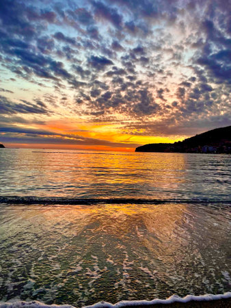 Beautiful dramatic sunset over the sea and mountainの写真素材