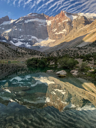 Majestic mountain, which is reflected in a perfectly clear blue lake waterの写真素材