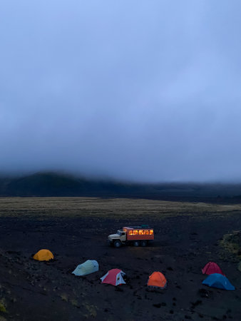 Camping camp for the night surrounded by mountains, volcanoes and clouds