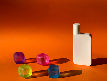 Cosmetic jar and coloured transparent cubes. Multicoloured shadows