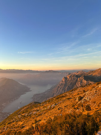Fantastic view from a huge height to the bay in the red sunset rays of the sunの写真素材