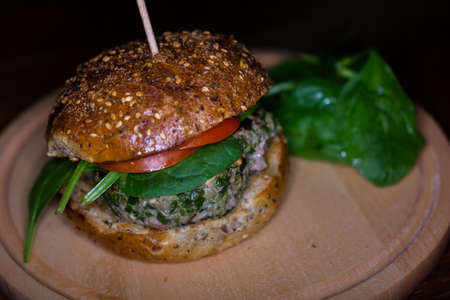 Juicy Beef Spinach Burger With Tomatoes Served With Baby Spinach Garnish Close-Upの写真素材
