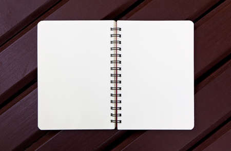 notebook isolated on wood backgroundの写真素材