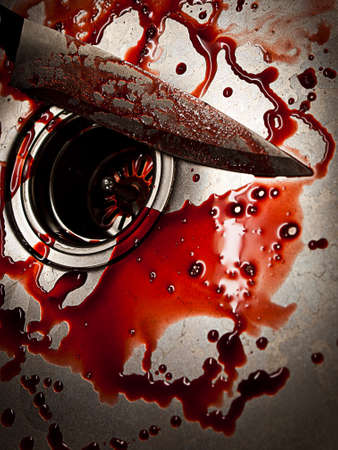 Bloody knife in kitchen sink for Halloween or crimeの写真素材