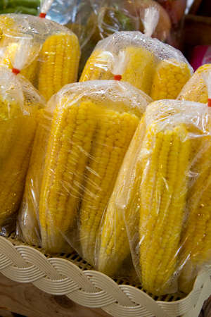 Steamed corn in a plastic bagの写真素材