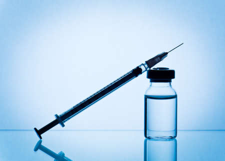 medical ampoules and syringe on blue backgroundの写真素材