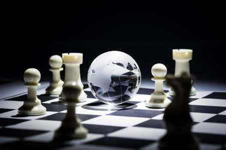 Glass globe on chess boardの写真素材