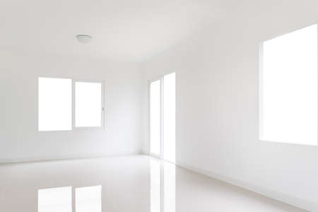 White room with a door and windowsの写真素材