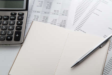 Pen, calculator and notebook on the financial account documents. Financial conceptの写真素材
