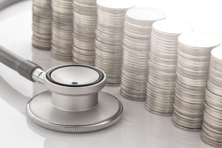 Stethoscope and Money on White background. Financial conceptの写真素材