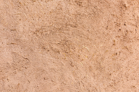 Full frame close-up of a adobe mud wall in New Mexico. The texture and straws are visible.の写真素材