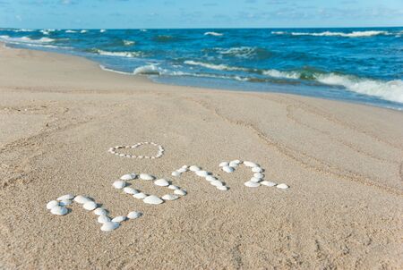 year 2012 written on sand with seashellsの写真素材